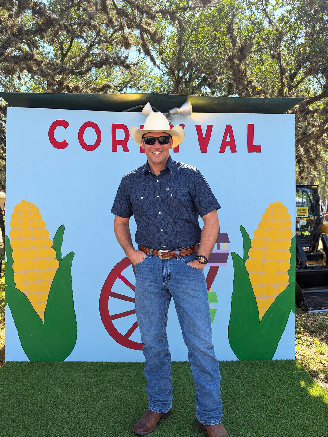 Josh Haley smiling in a cowboy hat at a local community event